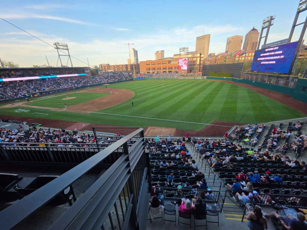 Baseball park with city skyline at sunset