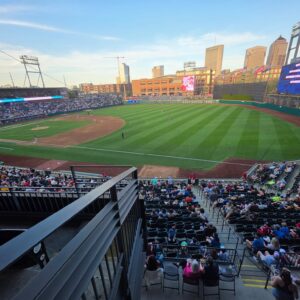 Baseball park with city skyline at sunset