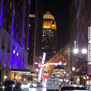 Downtown street and illuminated building at night