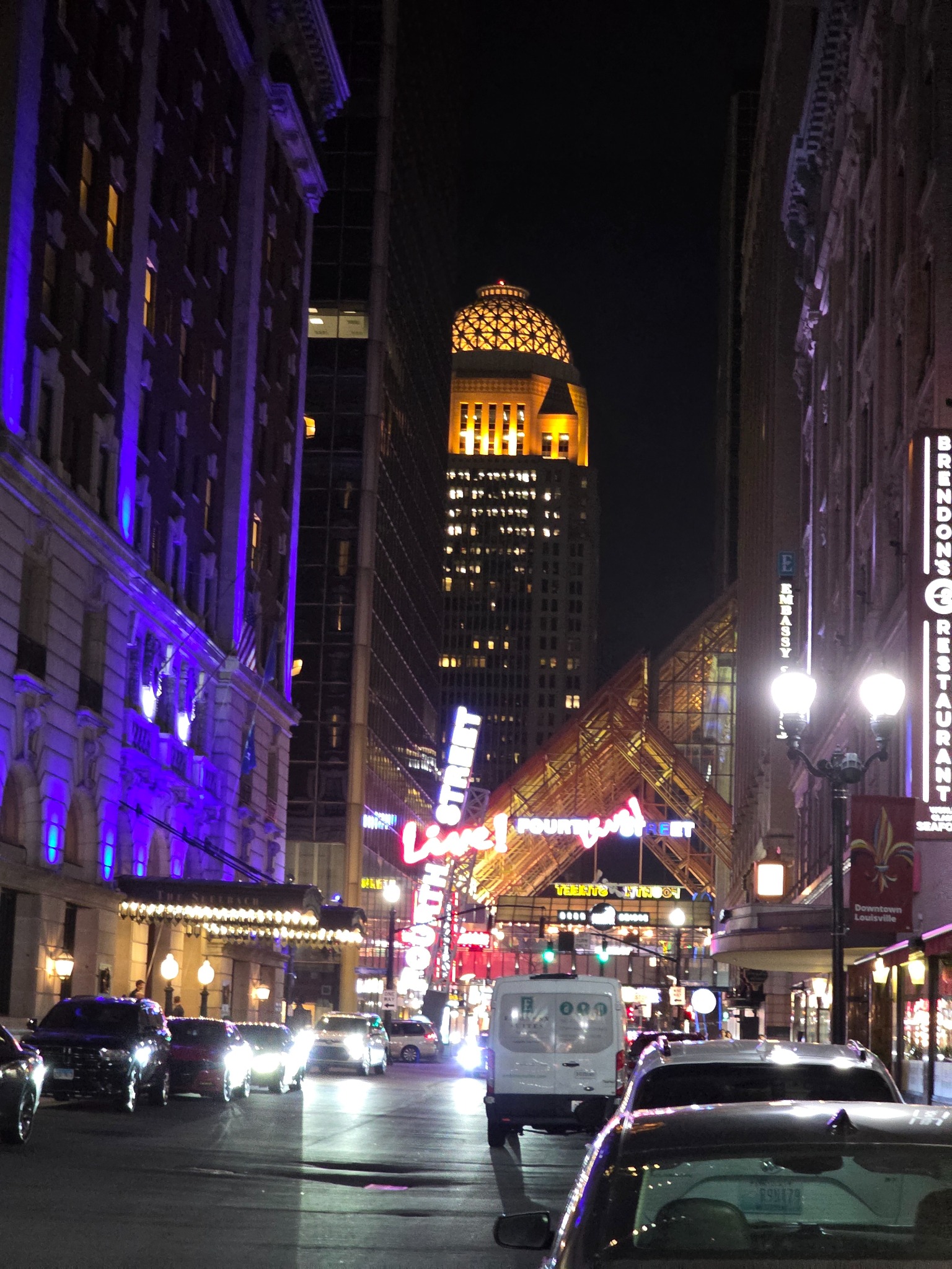 Downtown street and illuminated building at night