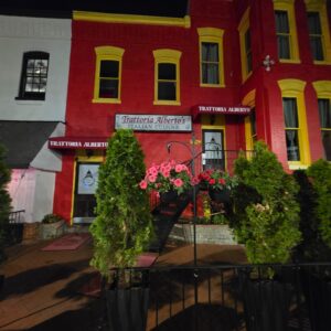 Colorful building and trees illuminated at night