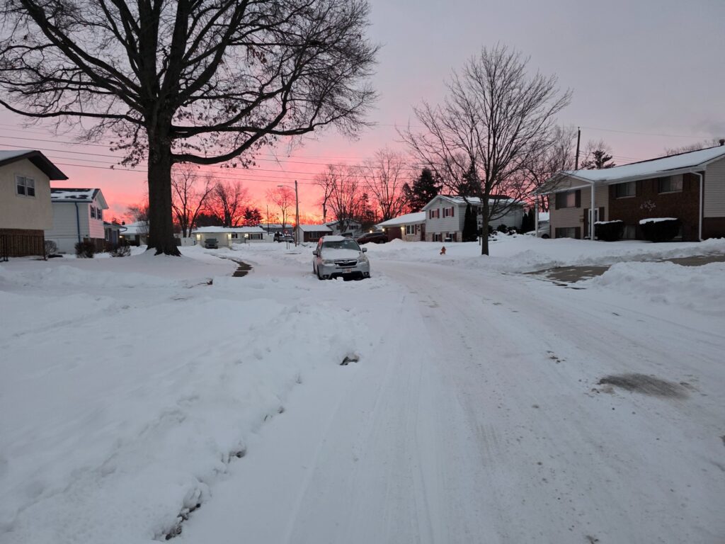 Winter neighborhood beneath a colorful dawn sky