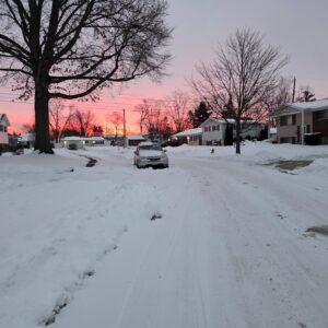 Winter neighborhood beneath a colorful dawn sky